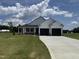 Charming, new construction home with a two car garage, concrete drive and manicured lawn on a sunny day at 47 Silver Ct, Smithfield, NC 27577