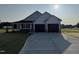 A charming, white two-car garage home with a well manicured lawn and concrete driveway at 47 Silver Ct, Smithfield, NC 27577
