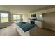 Bright open kitchen with an island, black stainless appliances and hardwood floors at 47 Silver Ct, Smithfield, NC 27577