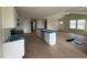 Modern kitchen with a large island, white cabinets, and stainless steel appliances at 47 Silver Ct, Smithfield, NC 27577