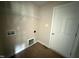 A bright laundry room with overhead shelving and hookups for a washer and dryer at 47 Silver Ct, Smithfield, NC 27577