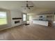 Spacious living room featuring wood-look floors, a fireplace with a wood mantle, and a ceiling fan at 47 Silver Ct, Smithfield, NC 27577