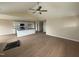 Open-concept living room and kitchen area, featuring wood-look floors and a ceiling fan at 47 Silver Ct, Smithfield, NC 27577