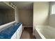 Main bathroom with double sinks, large mirror, and a separate tub and shower at 47 Silver Ct, Smithfield, NC 27577