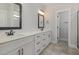 Modern bathroom featuring double sinks, framed mirrors, and updated fixtures at 48 Tanseyleaf Dr, Smithfield, NC 27577