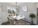 Staged dining room with wainscoting, hardwood floors, and seating for four at 48 Tanseyleaf Dr, Smithfield, NC 27577