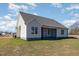 Exterior view of home features the screened in porch, green space and neutral color palette at 48 Tanseyleaf Dr, Smithfield, NC 27577