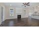 Open floor plan with hardwood floors, fireplace, and view into the kitchen at 48 Tanseyleaf Dr, Smithfield, NC 27577