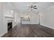 Open floor plan with hardwood floors, fireplace, and view into the kitchen at 48 Tanseyleaf Dr, Smithfield, NC 27577
