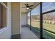 Screened porch featuring a ceiling fan and views of the fenced yard at 48 Tanseyleaf Dr, Smithfield, NC 27577