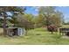 Spacious backyard with a dog run, dog house, fire pit, and two-tiered deck at 4810 Mitchell Mill Rd, Wake Forest, NC 27587