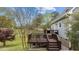 A spacious two-level wooden deck with an outdoor grill and seating area in the backyard at 4810 Mitchell Mill Rd, Wake Forest, NC 27587
