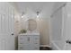 Well-lit bathroom featuring a modern vanity, round mirror, and shower with a curtain at 4810 Mitchell Mill Rd, Wake Forest, NC 27587