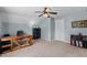 A bright room featuring a ceiling fan, a wooden desk with a chair and a view out the window at 4810 Mitchell Mill Rd, Wake Forest, NC 27587