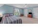 Cozy bedroom with serene blue walls, neutral carpet, and bright window views at 4810 Mitchell Mill Rd, Wake Forest, NC 27587