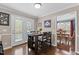 Cozy dining area adjacent to the kitchen, featuring a dark wood table and bar stool seating at 4810 Mitchell Mill Rd, Wake Forest, NC 27587