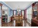 Formal dining room with hardwood floors, blue walls, and ample natural light at 4810 Mitchell Mill Rd, Wake Forest, NC 27587
