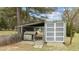 Outdoor dog kennel with shelter, enclosed by a chain-link fence and additional white-doored storage unit in backyard at 4810 Mitchell Mill Rd, Wake Forest, NC 27587