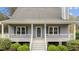 A welcoming front porch with white railings and stairs, perfect for relaxing outdoors at 4810 Mitchell Mill Rd, Wake Forest, NC 27587