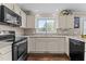 Spacious kitchen with granite counters, black appliances, and ample cabinet space at 4810 Mitchell Mill Rd, Wake Forest, NC 27587