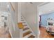 Classic staircase with wooden steps and white railing, connecting the home's living spaces at 4810 Mitchell Mill Rd, Wake Forest, NC 27587