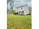 Spacious backyard featuring a deck, pergola, and lush green lawn, ideal for outdoor entertaining at 50 Teal Dr, Youngsville, NC 27596