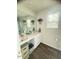Bright bathroom featuring a large mirror, sink with vanity, and window at 50 Teal Dr, Youngsville, NC 27596