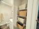 A closet next to the bathroom features shelves with decorative storage baskets at 50 Teal Dr, Youngsville, NC 27596