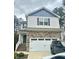 Two-story home with stone accents, attached garage, and well-maintained front yard at 50 Teal Dr, Youngsville, NC 27596