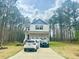 Charming two-story home with a well-manicured lawn and two cars parked in driveway at 50 Teal Dr, Youngsville, NC 27596