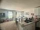 Open-concept living space with a kitchen island and stainless steel sink that seamlessly connects the living and dining areas at 50 Teal Dr, Youngsville, NC 27596