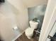 Compact toilet room with tile wall, providing a functional and tidy space at 50 Teal Dr, Youngsville, NC 27596