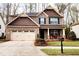 Charming two-story home with a two-car garage and inviting front porch seating at 507 Olsen Dr, Elon, NC 27244