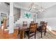 Elegant dining room with hardwood floors, wainscoting, and stylish lighting at 5317 Serather Ct, Garner, NC 27529