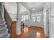 Bright foyer with hardwood floors, decorative front door, and staircase at 5317 Serather Ct, Garner, NC 27529