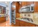 Close up of kitchen with stainless steel double oven, cooktop, and granite countertops at 5317 Serather Ct, Garner, NC 27529