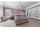 Elegant main bedroom with chandelier, large windows, and neutral decor at 5317 Serather Ct, Garner, NC 27529