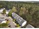 Aerial view of community showing multiple townhomes in a wooded area at 5430 Crabtree Park Ct, Raleigh, NC 27612