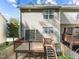 View of the back of the home showing the wooden deck and sliding glass doors at 5430 Crabtree Park Ct, Raleigh, NC 27612
