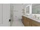 Stylish bathroom with dual sinks, modern vanity, glass-enclosed shower, and contemporary fixtures at 5430 Crabtree Park Ct, Raleigh, NC 27612