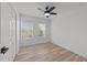 Bright bedroom featuring two windows, wood floors, white walls, a ceiling fan, and a closet at 5430 Crabtree Park Ct, Raleigh, NC 27612