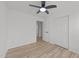 A cozy bedroom featuring wood floors, white walls, closet doors and a modern ceiling fan at 5430 Crabtree Park Ct, Raleigh, NC 27612