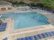 Aerial view of community pool with lounge seating and mature landscaping at 5430 Crabtree Park Ct, Raleigh, NC 27612