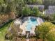 A refreshing community pool with lounge chairs and a spa surrounded by green trees at 5430 Crabtree Park Ct, Raleigh, NC 27612