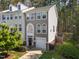 Townhome features neutral siding, attached garage, driveway, and mature landscaping at 5430 Crabtree Park Ct, Raleigh, NC 27612