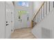 Bright foyer features a white door, stairs, and wood flooring at 5430 Crabtree Park Ct, Raleigh, NC 27612