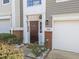 Charming townhome with brick accents, manicured landscaping, and attached garage at 5430 Crabtree Park Ct, Raleigh, NC 27612