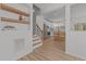 Open floor plan featuring a view into the kitchen, complete with stainless appliances and white cabinetry at 5430 Crabtree Park Ct, Raleigh, NC 27612