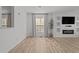 Living room with hardwood floors, modern fixtures, built ins, and a large window at 5430 Crabtree Park Ct, Raleigh, NC 27612
