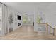 Bright living room with modern fixtures, large windows, fireplace, and wood flooring at 5430 Crabtree Park Ct, Raleigh, NC 27612